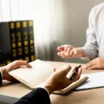 The lawyer and client discuss the lawsuit