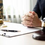 The lawyers sitting in their office is meticulously examining the judicial documents